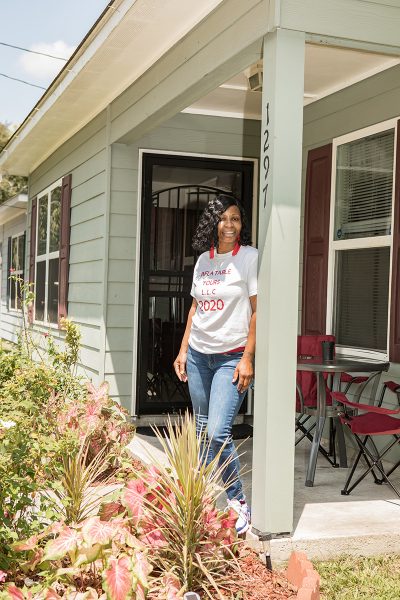 person standing on home porch